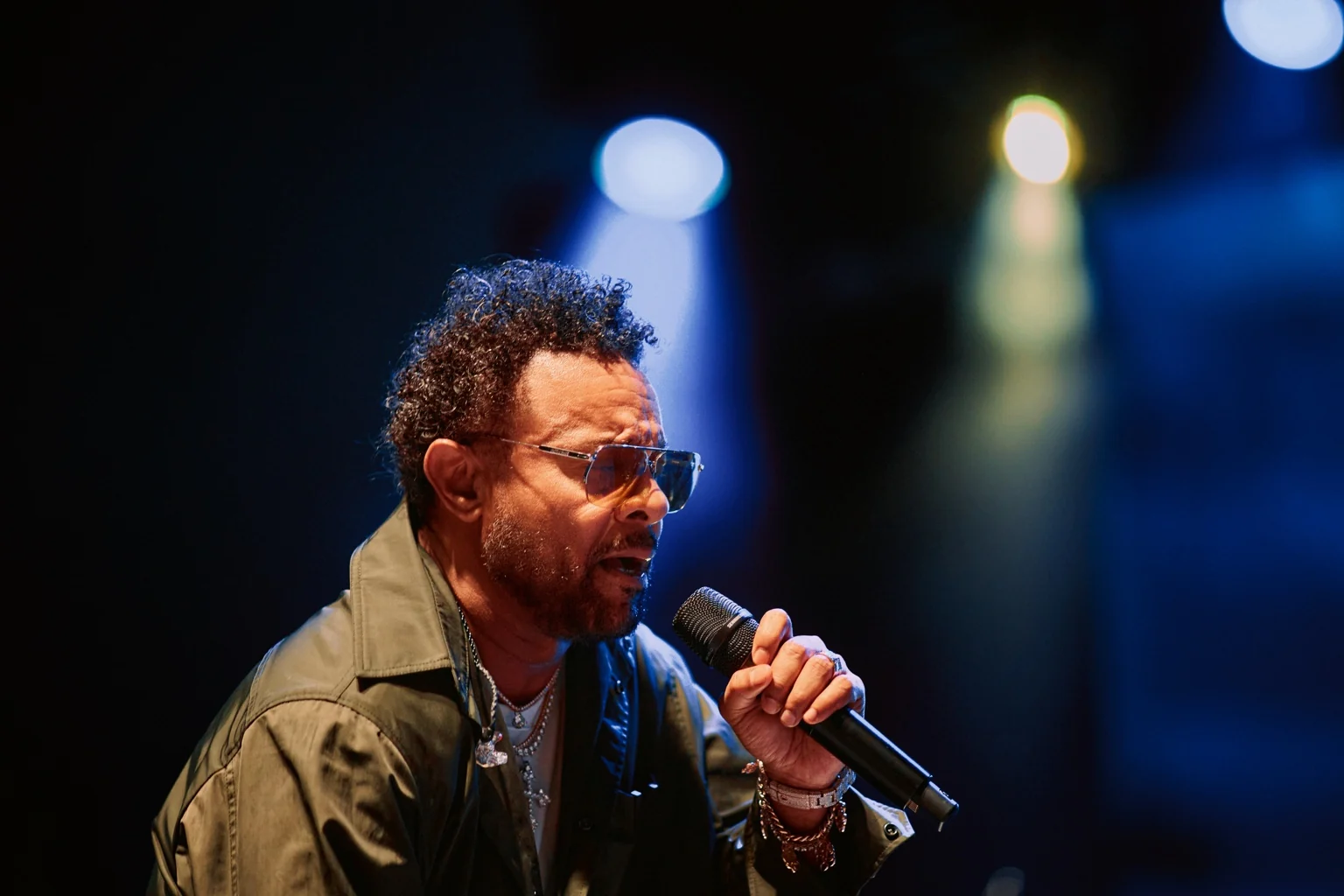 Singer performing on stage with a microphone