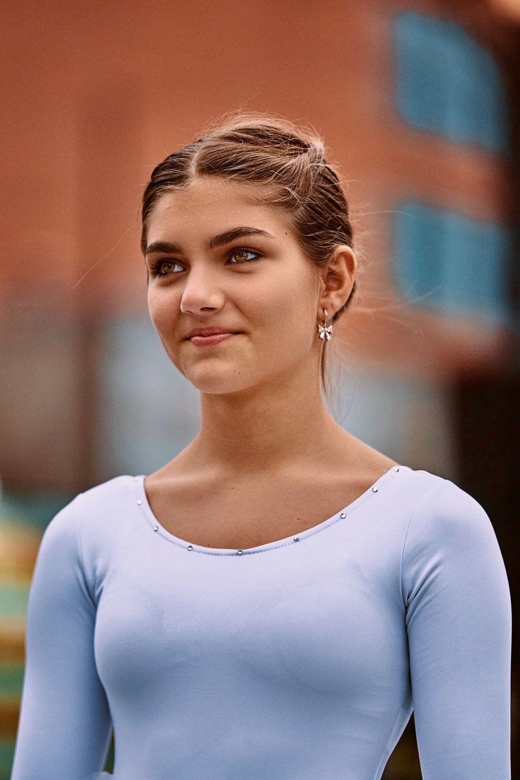 Young model in a light blue top outdoors